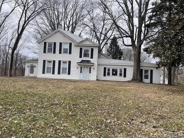 12255 Benham Rd, Saint Louis, MO 63138 - traditional home featuring a chimney and a front lawn