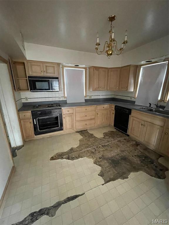 12255 Benham Rd, Saint Louis, MO 63138 - kitchen with black appliances, dark countertops, a chandelier, and backsplash