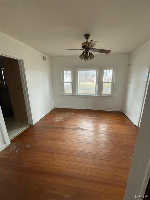 12255 Benham Rd, Saint Louis, MO 63138 - empty room featuring plenty of natural light, hardwood / wood-style floors, and a ceiling fan