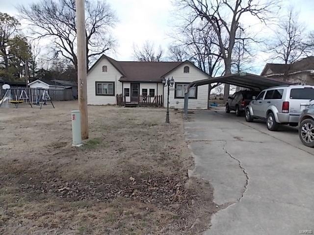 109 E Hicks, Cardwell, MO 63829 - view of front of house featuring a carport and a playground