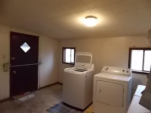 109 E Hicks, Cardwell, MO 63829 - washroom featuring washing machine and dryer and light wood-style flooring