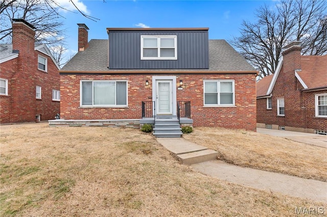 5807 Columbia Ave, Saint Louis, MO 63139 - view of front of house featuring brick siding, board and batten siding, a front yard, and a chimney