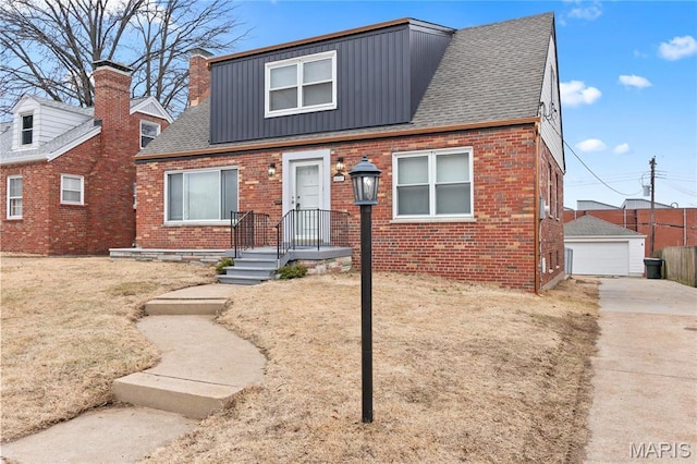 5807 Columbia Ave, Saint Louis, MO 63139 - view of front of home with brick siding, a garage, board and batten siding, and an outdoor structure
