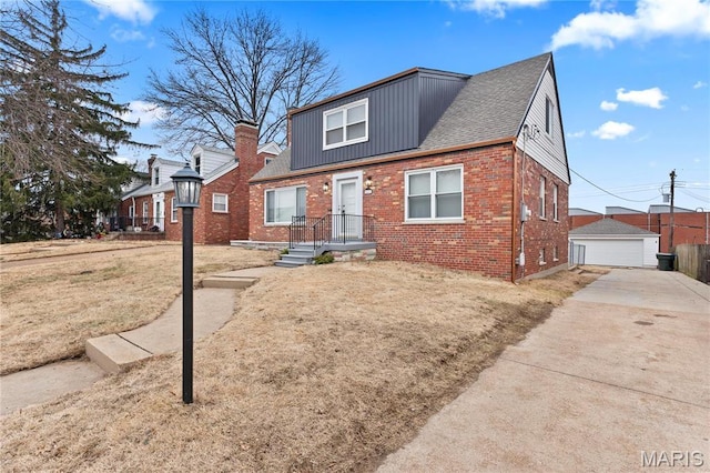 5807 Columbia Ave, Saint Louis, MO 63139 - view of front of house with brick siding, a garage, a shingled roof, an outbuilding, and a front yard