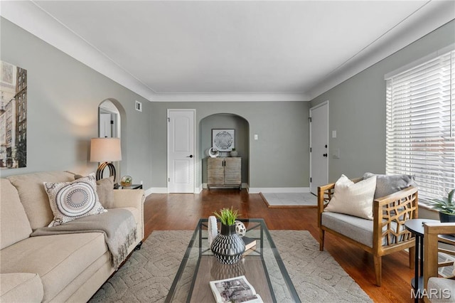 5807 Columbia Ave, Saint Louis, MO 63139 - living room featuring arched walkways, wood finished floors, and baseboards