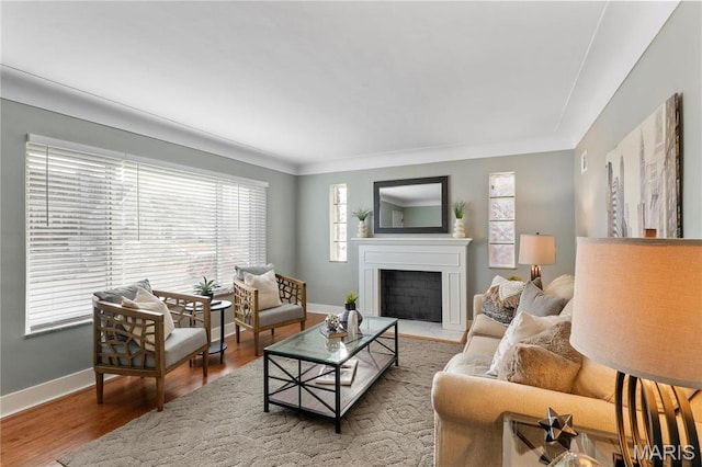 5807 Columbia Ave, Saint Louis, MO 63139 - living area featuring baseboards, a fireplace with flush hearth, and wood finished floors