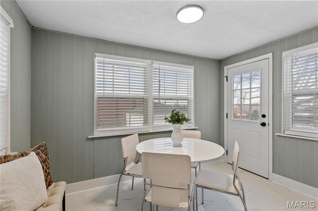 5807 Columbia Ave, Saint Louis, MO 63139 - dining area featuring marble finish floors, baseboards, and wooden walls