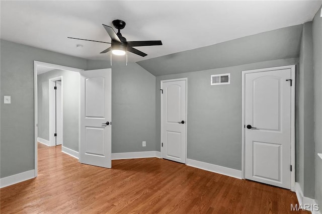 5807 Columbia Ave, Saint Louis, MO 63139 - unfurnished bedroom with light wood finished floors, baseboards, ceiling fan, and vaulted ceiling