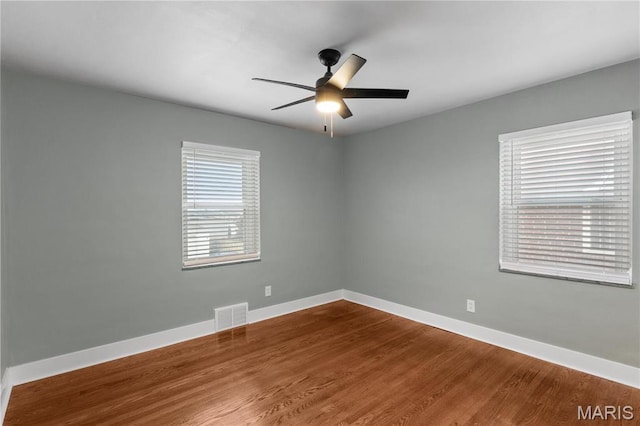 5807 Columbia Ave, Saint Louis, MO 63139 - unfurnished room with ceiling fan, dark wood-type flooring, and baseboards