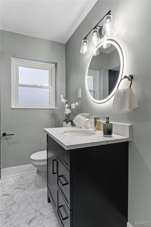 5807 Columbia Ave, Saint Louis, MO 63139 - bathroom featuring marble look tile flooring, vanity, toilet, and a chandelier