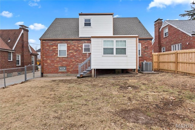 5807 Columbia Ave, Saint Louis, MO 63139 - rear view of house featuring cooling unit, brick siding, and a shingled roof