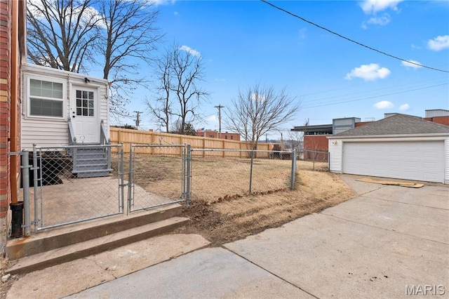 5807 Columbia Ave, Saint Louis, MO 63139 - view of yard with a gate, fence, a garage, and an outbuilding