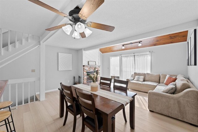 dining area with light wood-type flooring and a ceiling fan