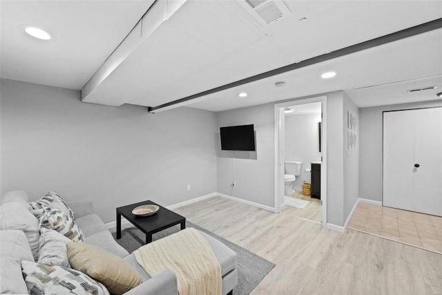 living room with baseboards, light wood finished floors, and recessed lighting