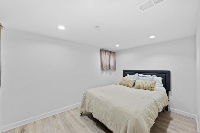 bedroom featuring wood finished floors, recessed lighting, and baseboards
