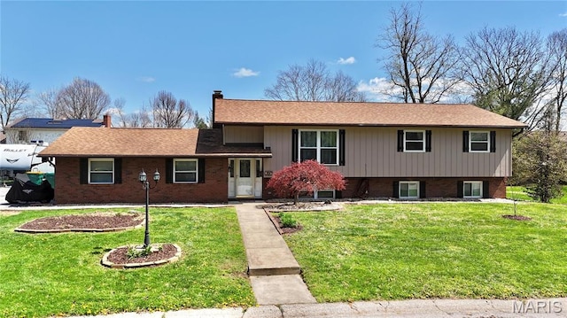 6 Ravenwood Cir, Ofallon, IL 62269 - tri-level home with a chimney, a front yard, brick siding, and roof with shingles
