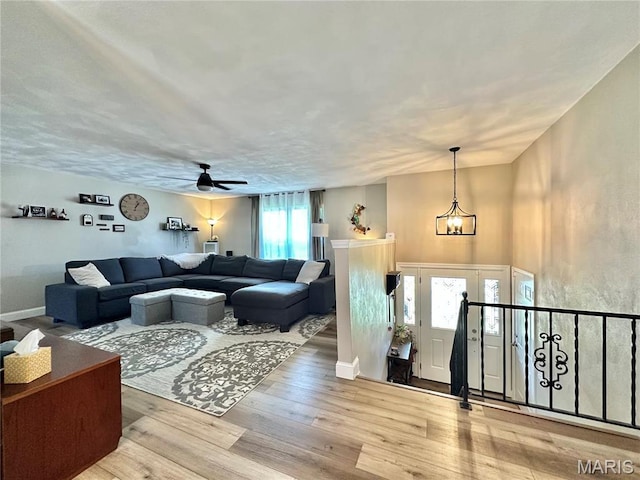 6 Ravenwood Cir, Ofallon, IL 62269 - living area featuring wood finished floors, ceiling fan, a chandelier, and baseboards