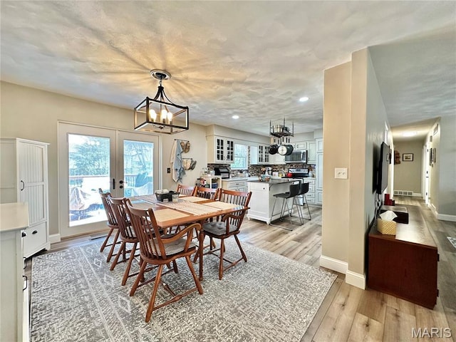 6 Ravenwood Cir, Ofallon, IL 62269 - dining area featuring french doors, light wood-style flooring, a chandelier, baseboards, and recessed lighting