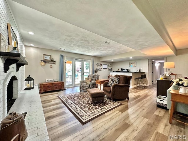 6 Ravenwood Cir, Ofallon, IL 62269 - living room with light wood-type flooring, a brick fireplace, and recessed lighting
