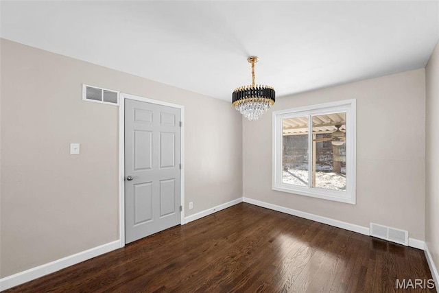 8646 Spoon Dr, Saint Louis, MO 63132 - spare room with a chandelier, dark wood-type flooring, and baseboards