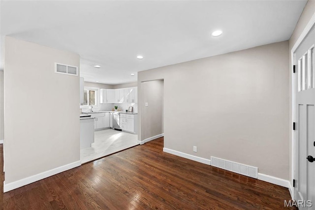 8646 Spoon Dr, Saint Louis, MO 63132 - unfurnished living room with baseboards, light wood-style flooring, recessed lighting, and a sink