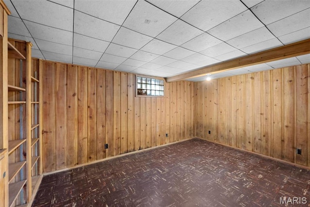 8646 Spoon Dr, Saint Louis, MO 63132 - below grade area featuring wooden walls, baseboards, and a paneled ceiling