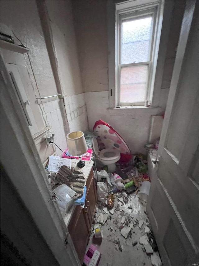 1047 Hornsby Ave, Saint Louis, MO 63147 - bathroom featuring toilet, vanity, and a wainscoted wall