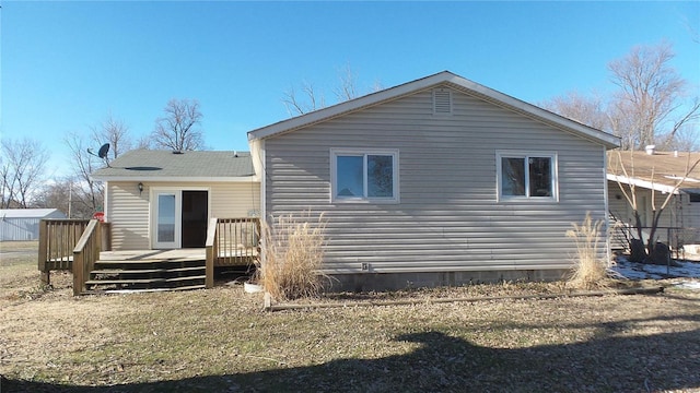back of property featuring a deck, crawl space, and a lawn