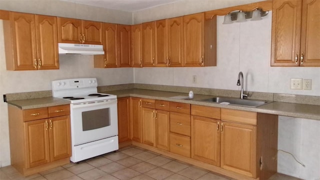 kitchen featuring white range with electric cooktop, under cabinet range hood, a sink, light tile patterned floors, and light countertops