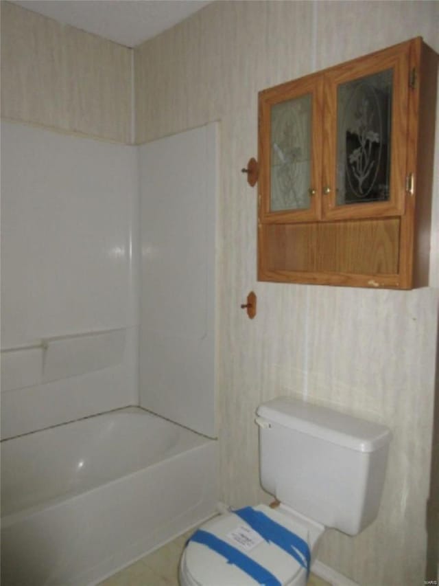 full bathroom with toilet and tile patterned flooring