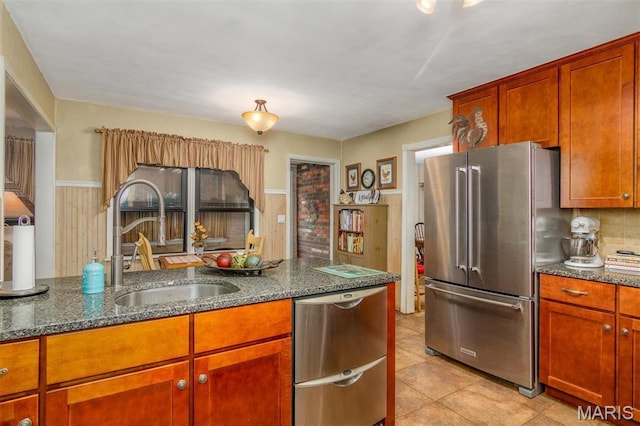 3 Echo Ln, Centralia, IL 62801 - kitchen featuring appliances with stainless steel finishes, a sink, dark stone counters, brown cabinets, and light tile patterned floors