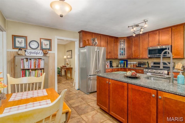 3 Echo Ln, Centralia, IL 62801 - kitchen featuring stainless steel appliances, a sink, dark stone countertops, glass insert cabinets, and tasteful backsplash