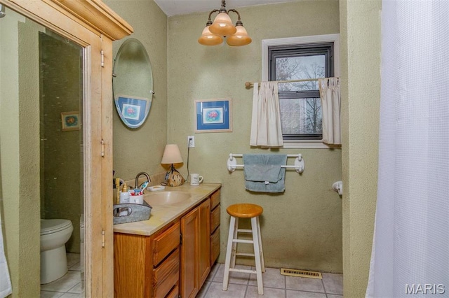 3 Echo Ln, Centralia, IL 62801 - bathroom with tile patterned floors, a chandelier, toilet, and vanity