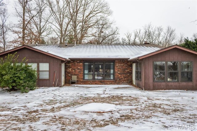 3 Echo Ln, Centralia, IL 62801 - snow covered rear of property with a chimney and brick siding