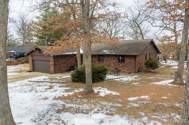 3 Echo Ln, Centralia, IL 62801 - snow covered property with brick siding, driveway, roof with shingles, and an attached garage