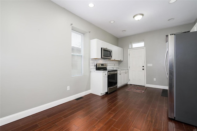 7915 S Broadway, Saint Louis, MO 63111 - kitchen with stainless steel appliances, baseboards, light countertops, white cabinets, and dark wood-style flooring