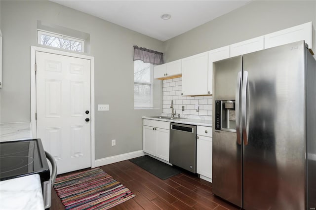 7915 S Broadway, Saint Louis, MO 63111 - kitchen with appliances with stainless steel finishes, light countertops, a sink, dark wood finished floors, and white cabinetry