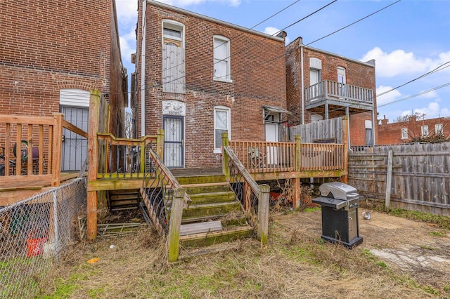 5029 Wells Ave, Saint Louis, MO 63113 - back of property featuring brick siding, a deck, and fence