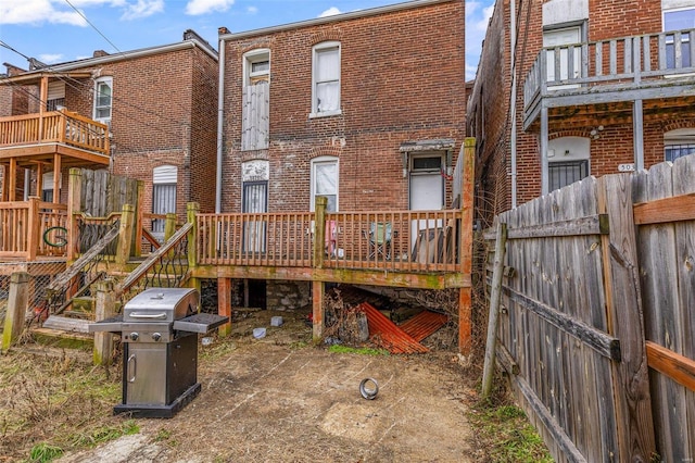 5029 Wells Ave, Saint Louis, MO 63113 - back of property featuring brick siding, fence, and a wooden deck