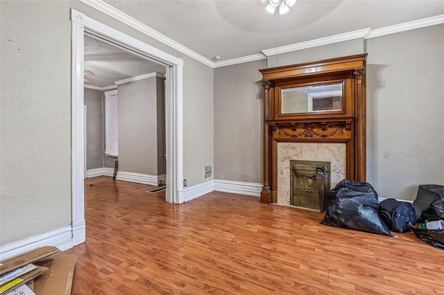 5029 Wells Ave, Saint Louis, MO 63113 - unfurnished living room featuring wood finished floors, crown molding, a fireplace, ceiling fan, and a textured ceiling