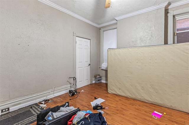 5029 Wells Ave, Saint Louis, MO 63113 - empty room featuring wood finished floors, a textured wall, ornamental molding, and baseboards