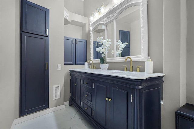 1317 Shenandoah Ave, Saint Louis, MO 63104 - bathroom with marble finish flooring, double vanity, and baseboards