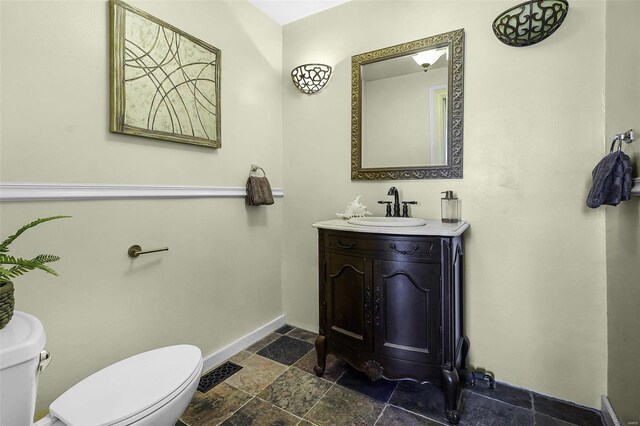 1317 Shenandoah Ave, Saint Louis, MO 63104 - bathroom featuring stone tile flooring, toilet, baseboards, and vanity