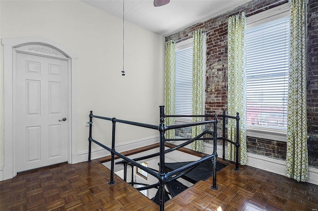 1317 Shenandoah Ave, Saint Louis, MO 63104 - staircase with brick wall and baseboards