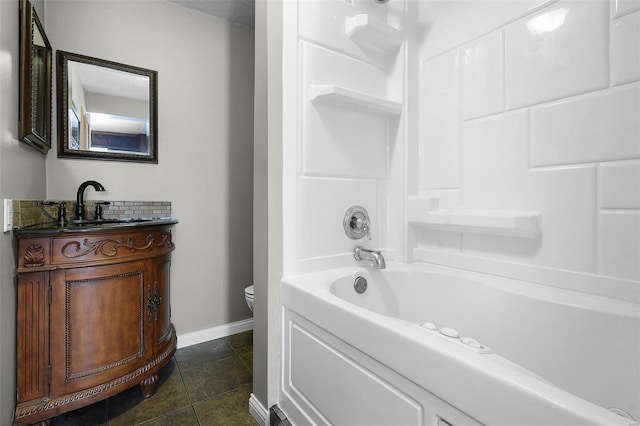 1317 Shenandoah Ave, Saint Louis, MO 63104 - bathroom featuring toilet, vanity, tile patterned flooring, baseboards, and washtub / shower combination