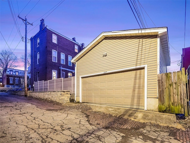 1317 Shenandoah Ave, Saint Louis, MO 63104 - view of side of home with fence, an outdoor structure, and a garage