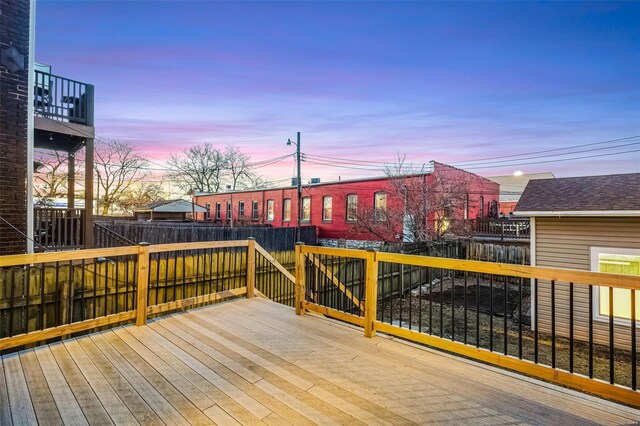 1317 Shenandoah Ave, Saint Louis, MO 63104 - deck at dusk featuring a fenced backyard