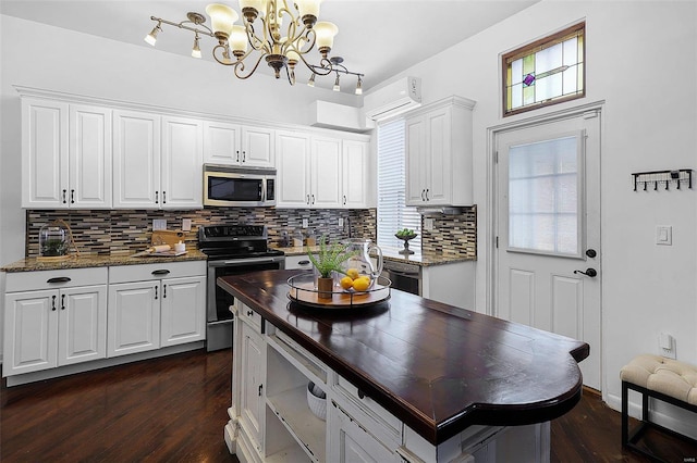 1317 Shenandoah Ave, Saint Louis, MO 63104 - kitchen featuring stainless steel appliances, wooden counters, backsplash, dark wood finished floors, and white cabinets