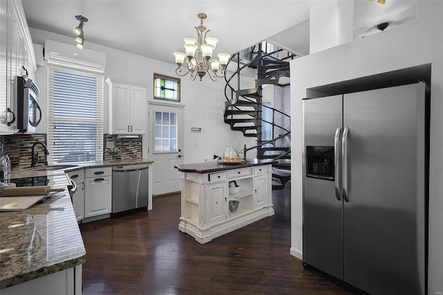 1317 Shenandoah Ave, Saint Louis, MO 63104 - kitchen featuring stainless steel appliances, open shelves, an AC wall unit, backsplash, and white cabinetry