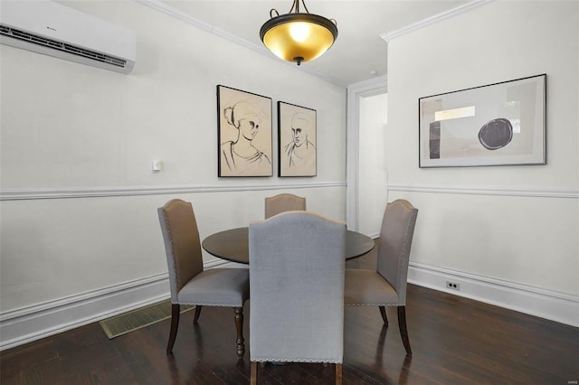 1317 Shenandoah Ave, Saint Louis, MO 63104 - dining room featuring an AC wall unit, wood finished floors, crown molding, and baseboards